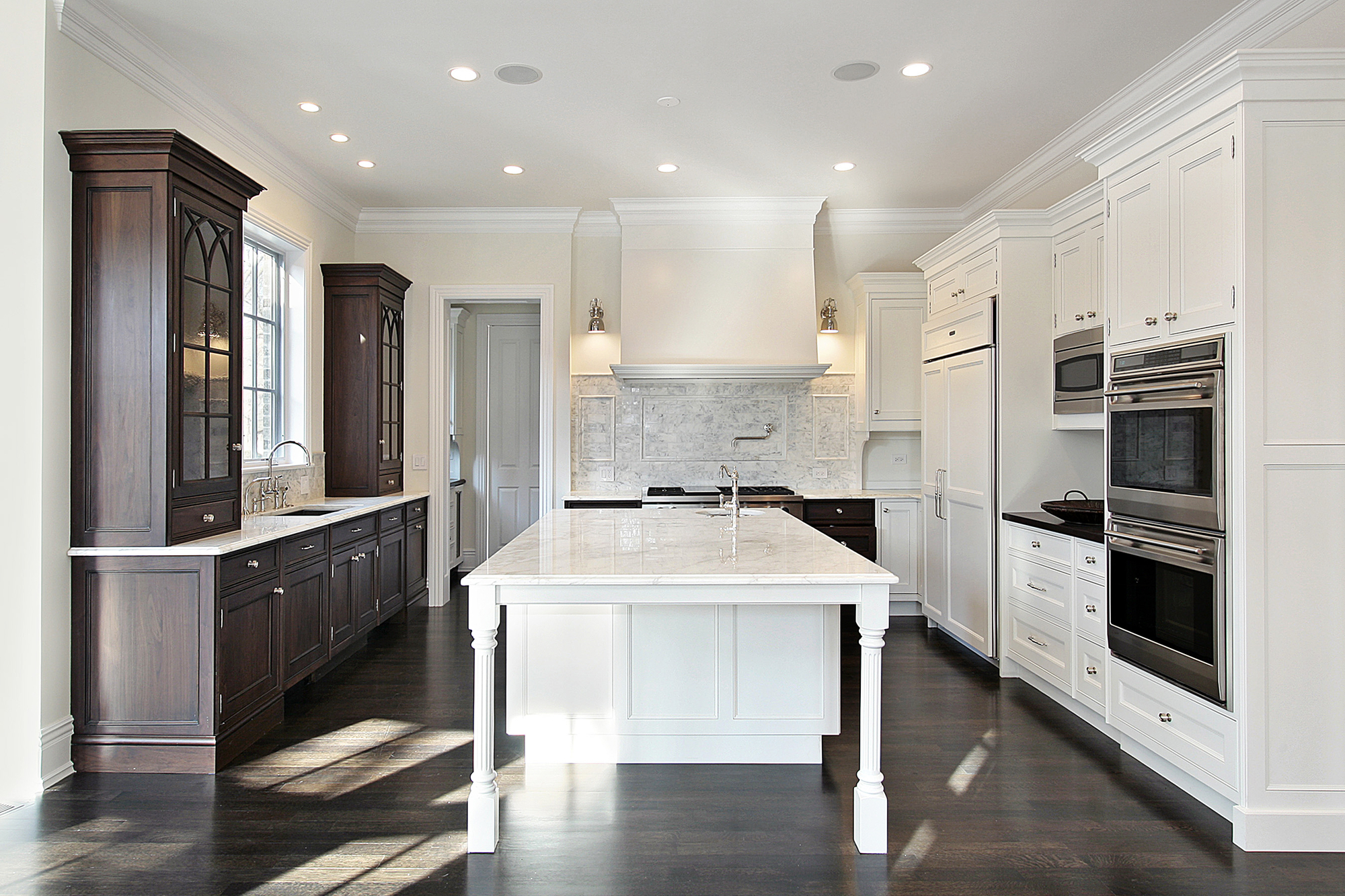 Finished kitchen with island, cabinetry, and wood flooring