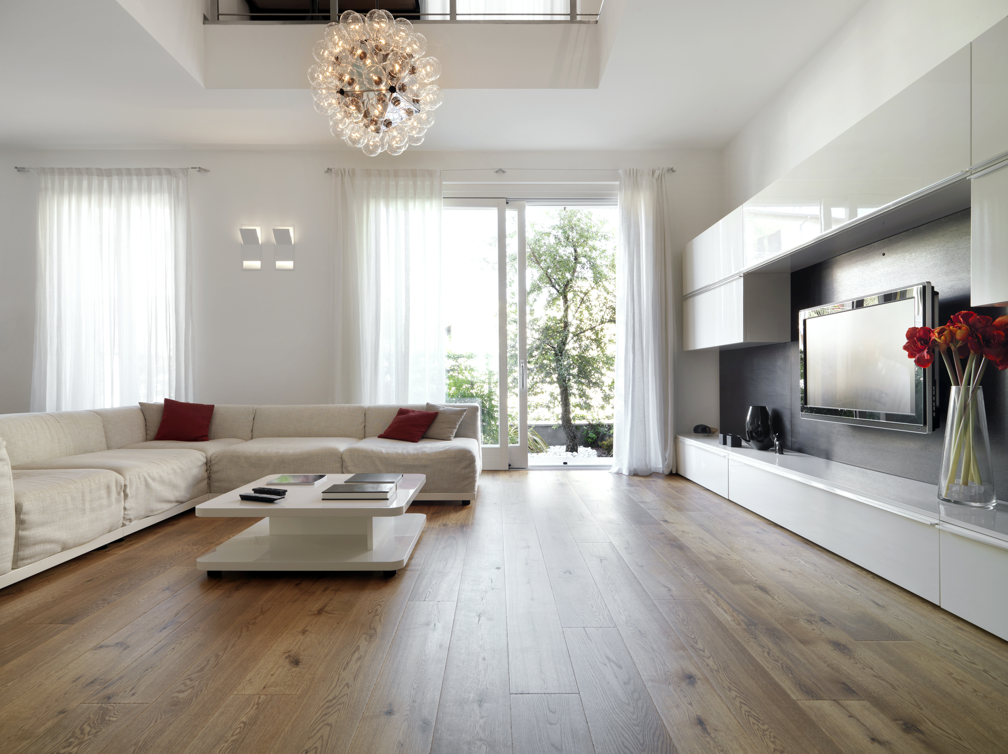 Finished living room with windows and wood flooring